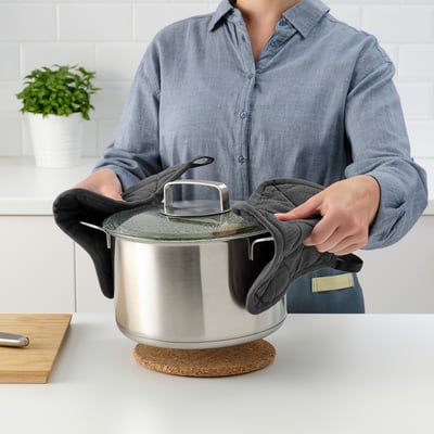 Person holding lid and cloth in kitchen
