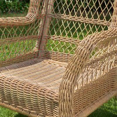 Woven wicker patio chair showcasing intricate craftsmanship, highlighting its durable, weather-resistant design.