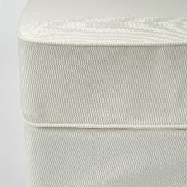 Close-up of clean, white sofa fabric with detailed piping and pleats, showcasing quality and texture.