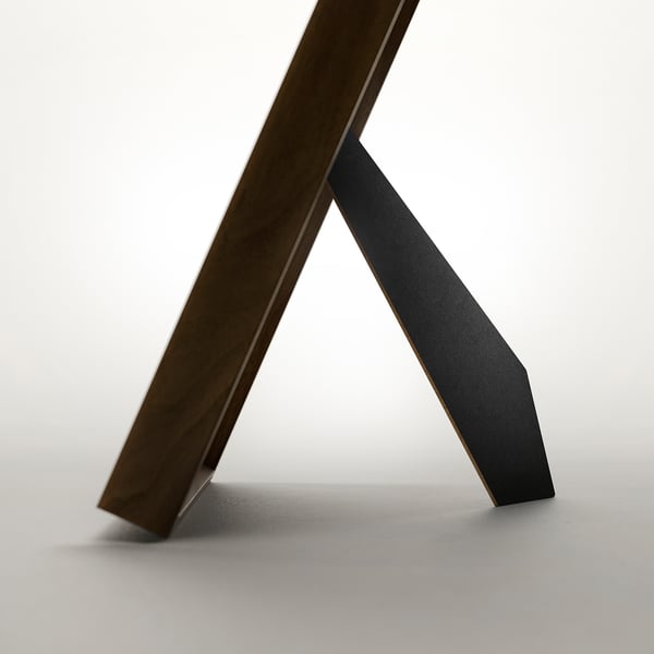 A sleek, modern picture frame with an angled support, capable of vertical or horizontal display, and featuring front picture placement.