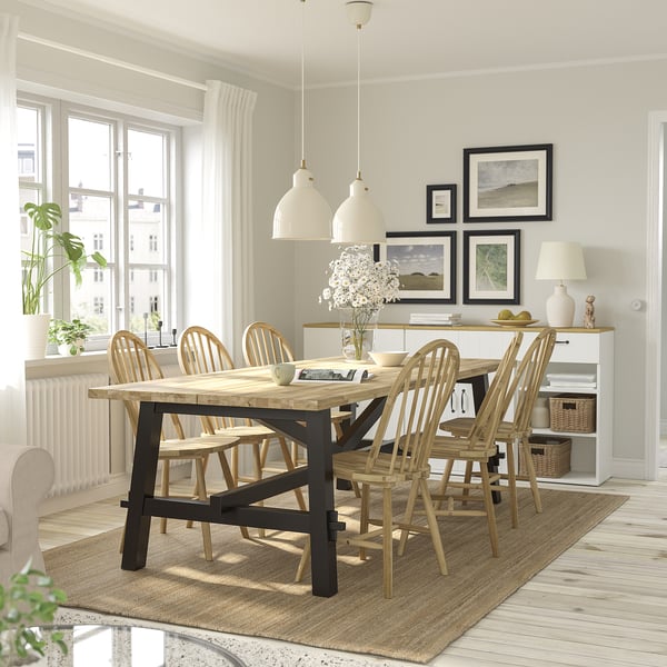 Modern dining room with wooden table & chairs, RÖDFLIK pendant lamps, large window, art & side lamp.