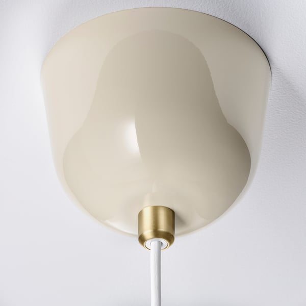 Modern pendant lamp with smooth, beige shade, gold base, and white cord.