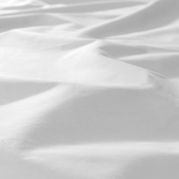 Crisp, soft bedsheet with intricate shadows, indicating high-quality texture and weave.