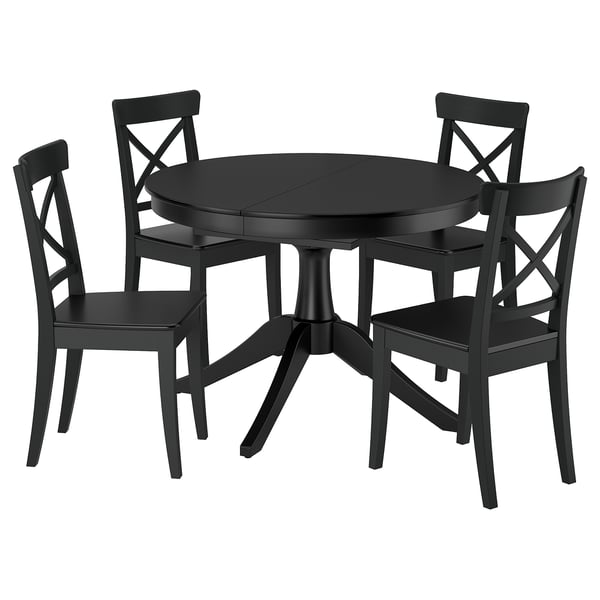 Black ROSENTORP extendable round dining table with four chairs. Scratch-resistant, expandable, and sturdy wooden legs.