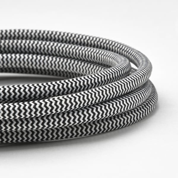 Black and white zigzag patterned charging cable bundled neatly.