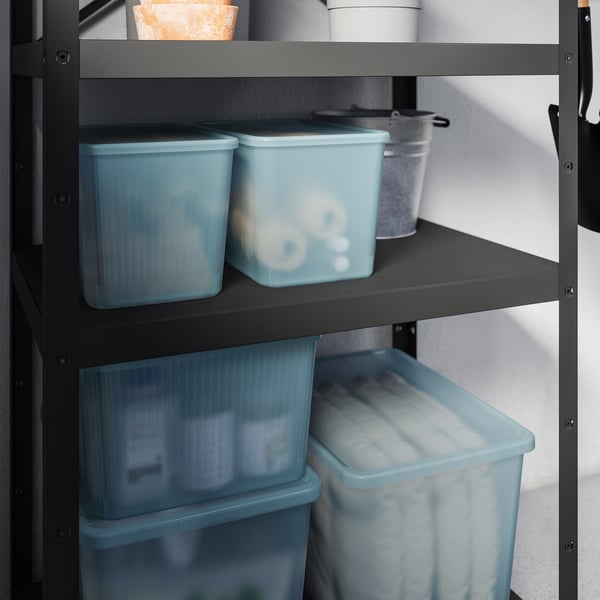 Shelf with blue plastic storage boxes, each with lid, for organising items.