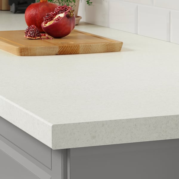 A modern kitchen countertop a light grey stone effect SÄLJAN worktop with rounded edges, highlighting its durable and easy-to-clean laminate surface.