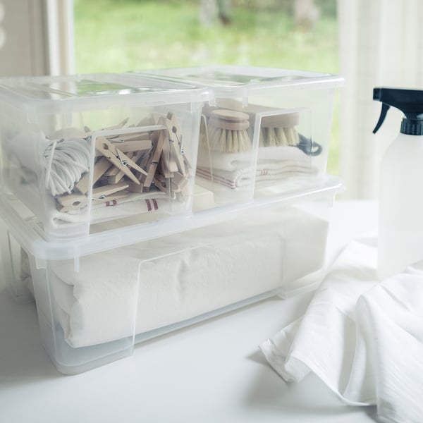 Clear SAMLA boxes - clothespins, brushes, sponges. Stacked by window.