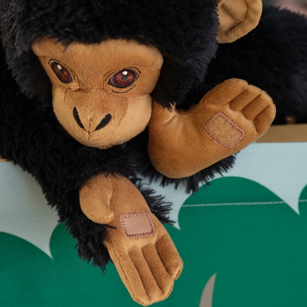 A cuddly toy monkey with realistic details, conveying cuddly softness.