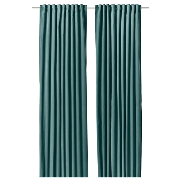Two dark grey-turquoise SANELA curtains hang side by side, featuring a luxurious velvet texture and a multi-way header design.