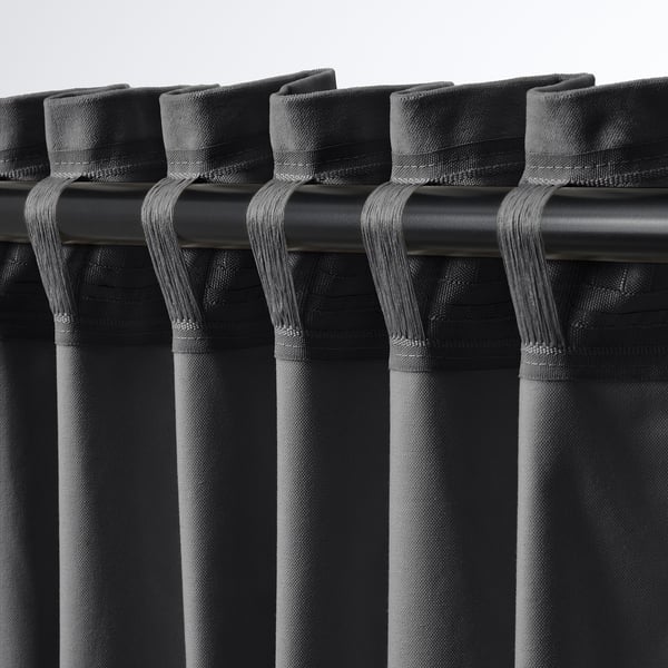 Close-up of dark grey curtains with tab headers, showcasing rod pockets and hanging hooks, highlighting versatile hanging options.