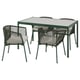 Green outdoor dining set with glass table, 4 woven chairs & beige cushions, table has umbrella hole.