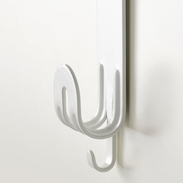 White metal hook, securely mounted on a door, featuring three prongs for hanging items.
