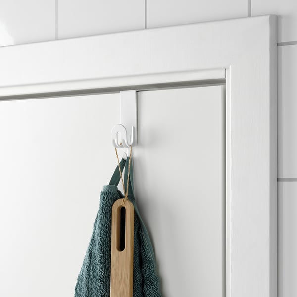 Door hook with towel and wooden spatula.
