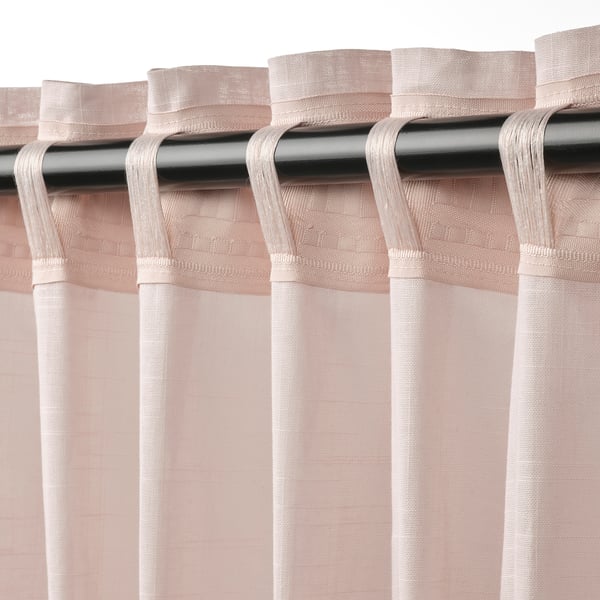 Pink SILVERLÖNN curtains with linen texture and sheer fabric diffusion.