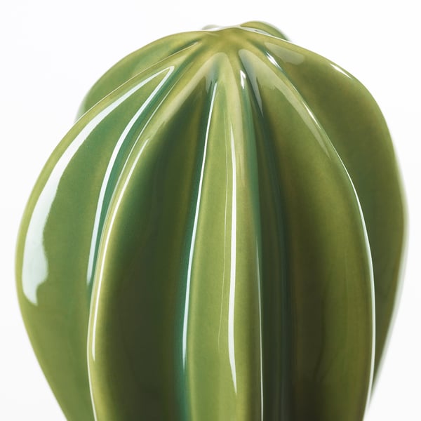Green vase with vertical ridges, glossy finish.