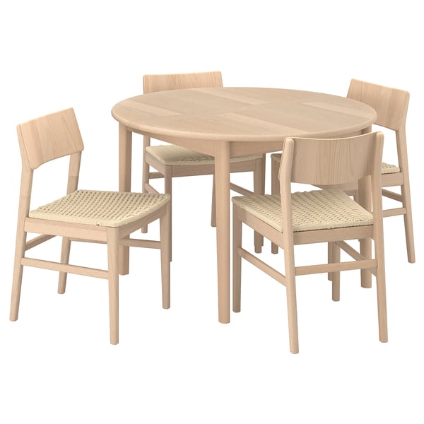 A light-brown scandinavian-style dining set with a round table and four wicker-clad chairs.
