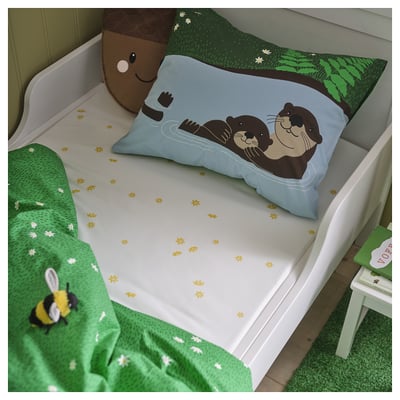 Blue bear bed with green blanket & stool, cuddly toy, tree print.