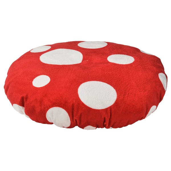 A red, circular cushion with white polka dots, designed for children.