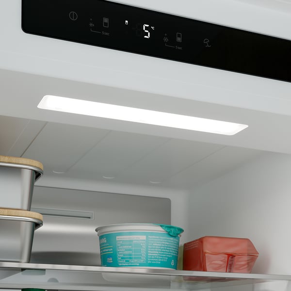 Fridge interior with led light on. Shelves hold containers, showing no-frost tech.