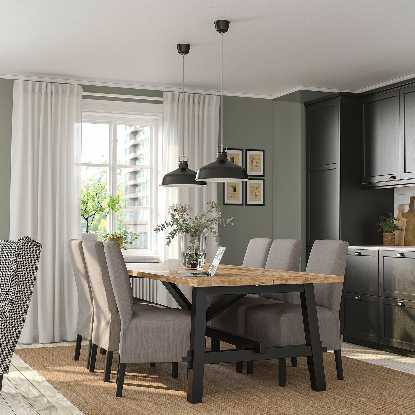 Modern dining area with SKOGSTA table and grey chairs, black pendant lights, green wall, and large window with white curtains.