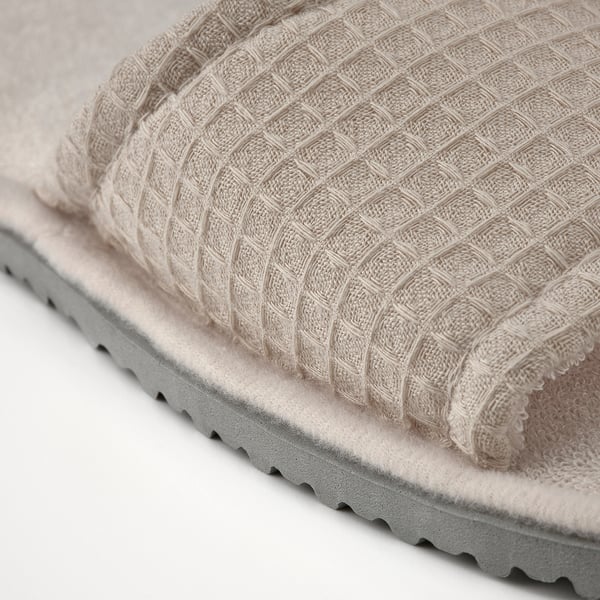 Close-up of soft, textured slippers with cushioned sole.