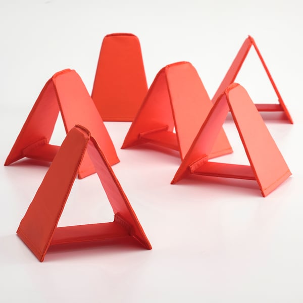 Six bright red triangular obstacles arranged in a semi-circle, robust and neatly crafted, perfect for childrens play.