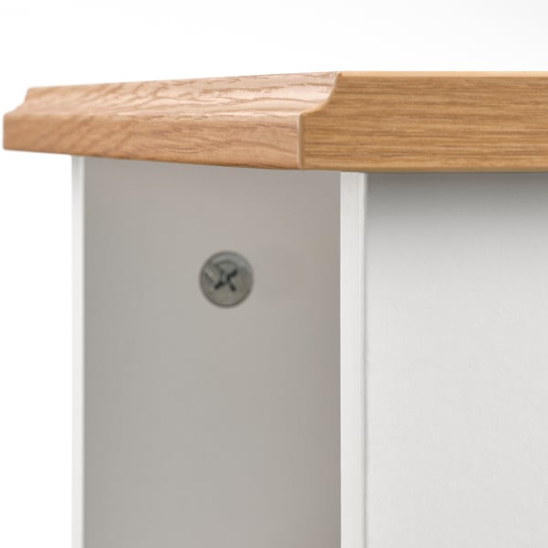 Close-up of SKRUVBY table edge: smooth oak, sleek design.