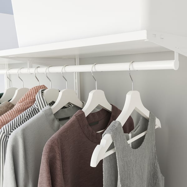 Wall-mounted closet organiser with clothes hangers and garments, part of boaxel system, aiding laundry storage and drying.
