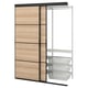 A wooden and metal SKYTTA wardrobe with sliding doors and wire baskets. It has three compartments and a hanging rod.