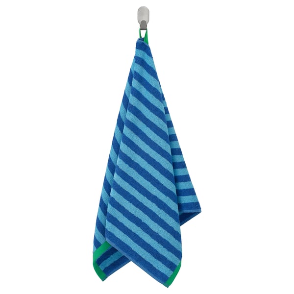 SLÅNHÖSTMAL blue & green striped cotton towel hangs on a hook.