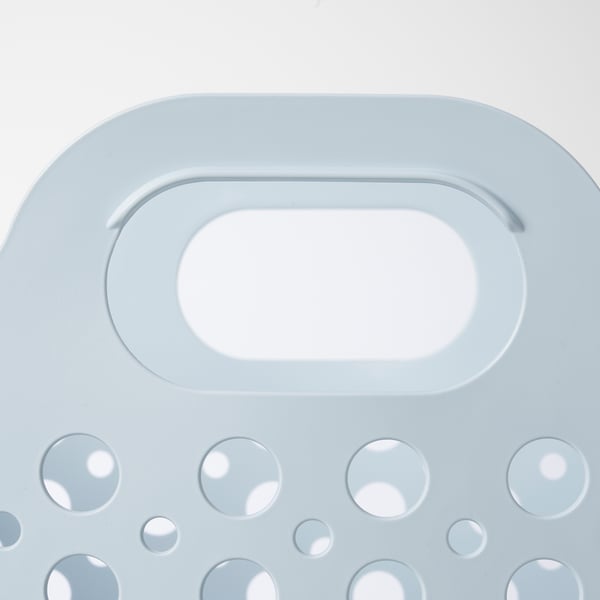 Light blue plastic laundry basket with large circular cutouts; strong, flexible design; ideal for carrying clothes.