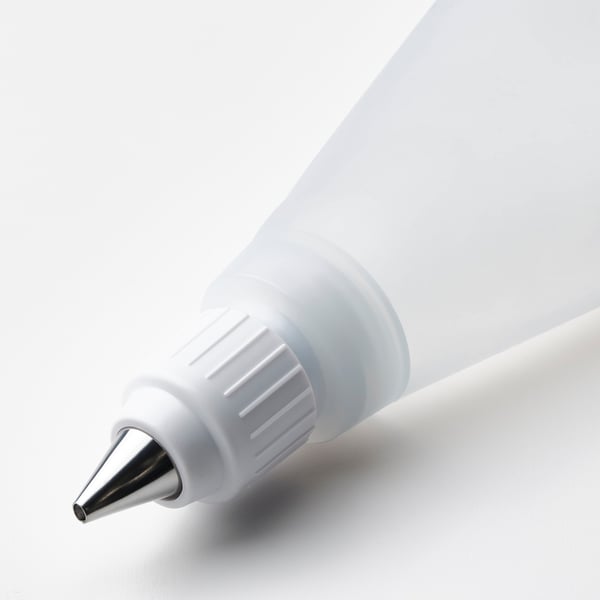 Close-up of high-quality, stainless steel nozzle on flexible silicone piping tool.