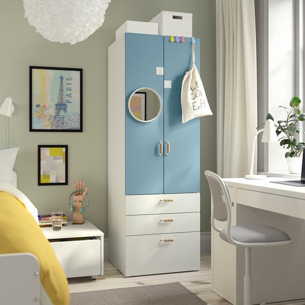 Shows childs light blue SMÅSTAD wardrobe in bedroom with bed and desk.