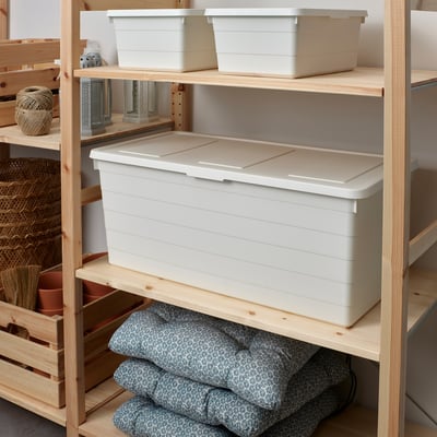 White SOCKERBIT storage boxes on wooden shelves, large box centre with small on top, grey fabric below.