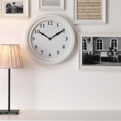 Wall clock with silent quartz, framed photos, lamp.