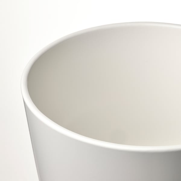 Close-up of a sleek, white plant pots smooth, curved rim and inner surface.