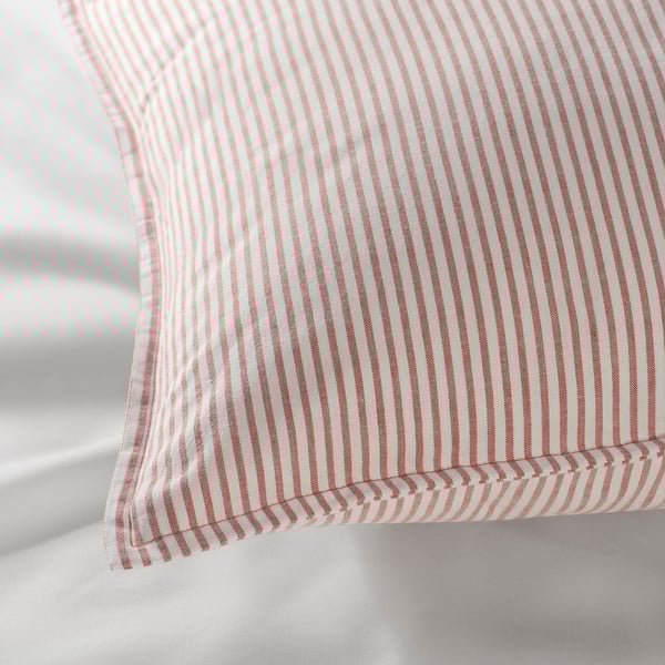Close-up of red and white striped cotton pillow, showcasing fabric texture and neatly stitched edges.
