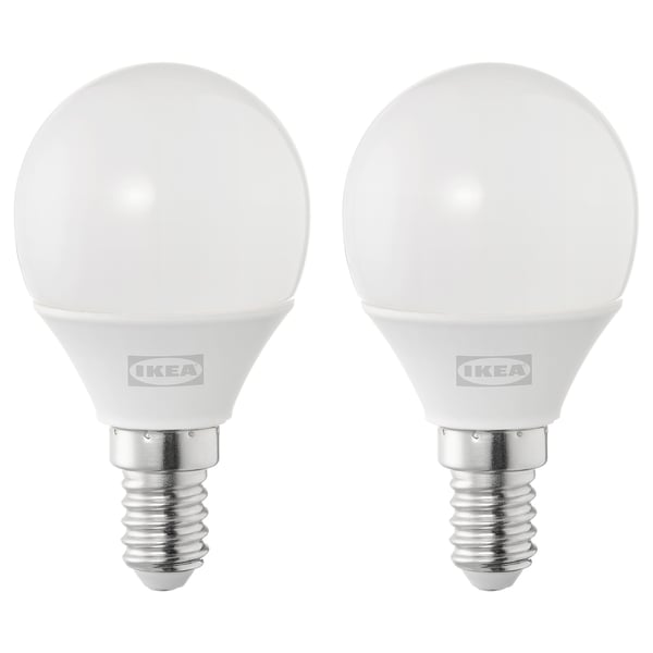 Two ikea led light bulbs, round and white, made of plastic.