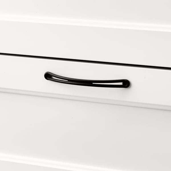 Black handle on sleek white drawer, smooth and modern design.