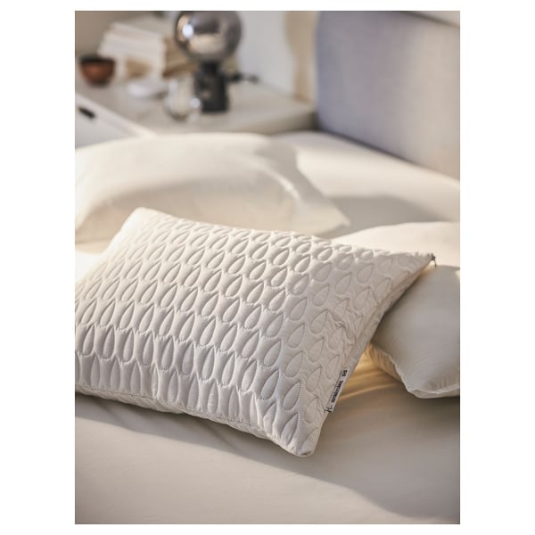 White pillow protector on bed, designed with quilted pattern, waterproof layer, made from recycled polyester.