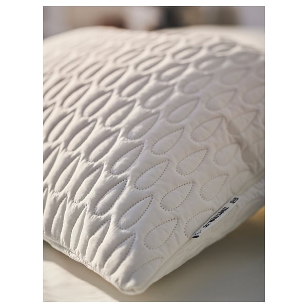 White pillow protector with quilted pattern, soft wadding, and subtle branding, showcasing quality design and comfort.