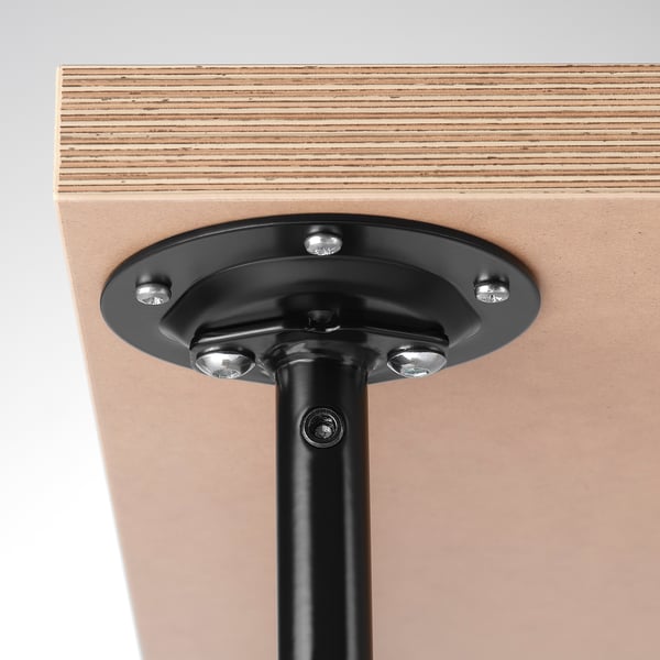 Metal leg attached to wooden table.