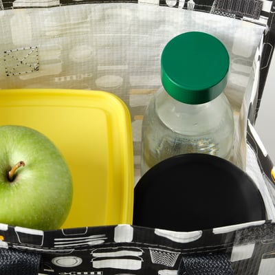 Black insulated bottle holder with yellow container and green apple, shown with SPARTANSK bottle.
