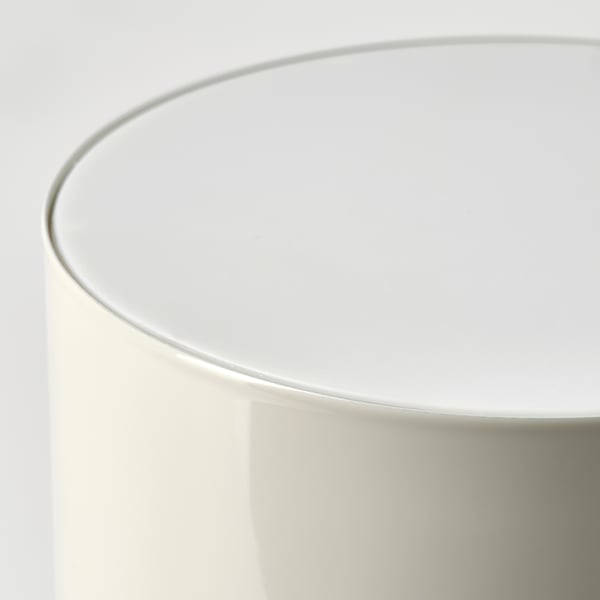 Modern table lamp with sleek white design, smooth edges, and rounded top, emitting soft, comforting light.