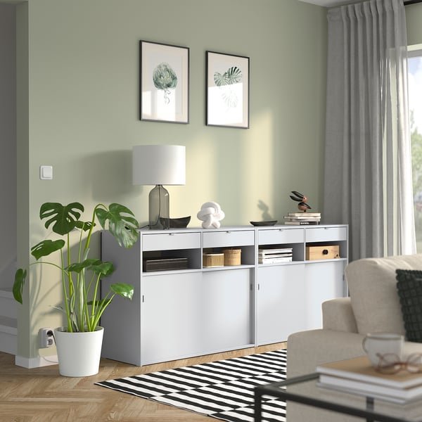 Cosy room white SPIKSMED sideboard, modern plant, and stylish decor.