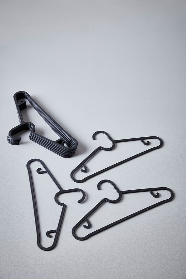 Black plastic hangers; slim, space-saving design; lay flat; three different shapes; stackable.