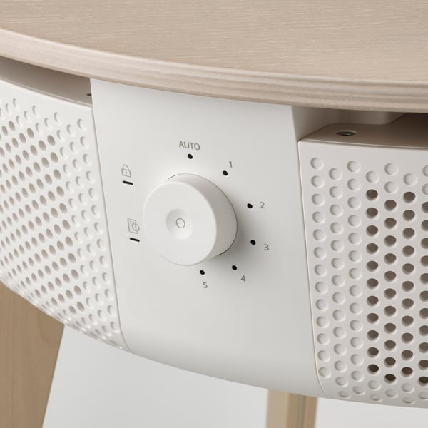 A sleek, modern air purifier table with a control dial, perforated ventilation holes, and a light wooden tabletop.