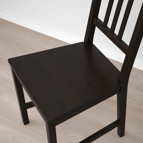 Dark wood chair with squared seat and back, solid construction, clean lines, placed on light wood floor.