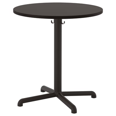 Depicts a black, round STENSELE table with a sleek design, featuring a central support and four stabilising legs, ideal for cafés or small spaces.